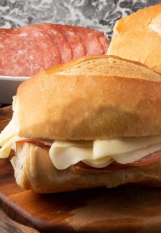 Traditional Brazilian snack French bread stuffed with salami and cheese